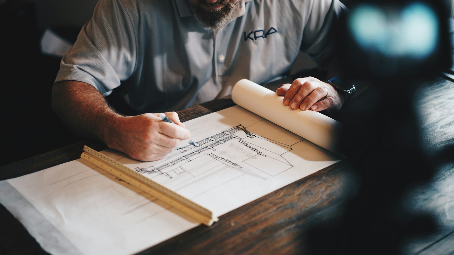 A planning drawing being prepared at a desk